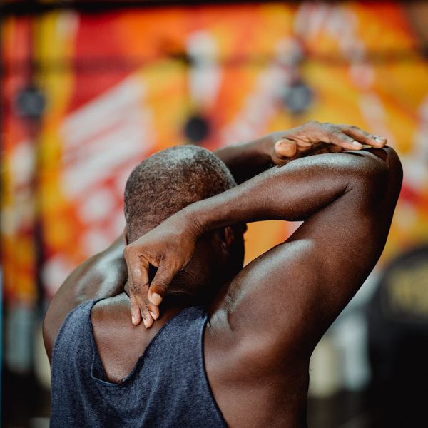 Silhouette of a man stretching, symbolizing energy and flexibility.